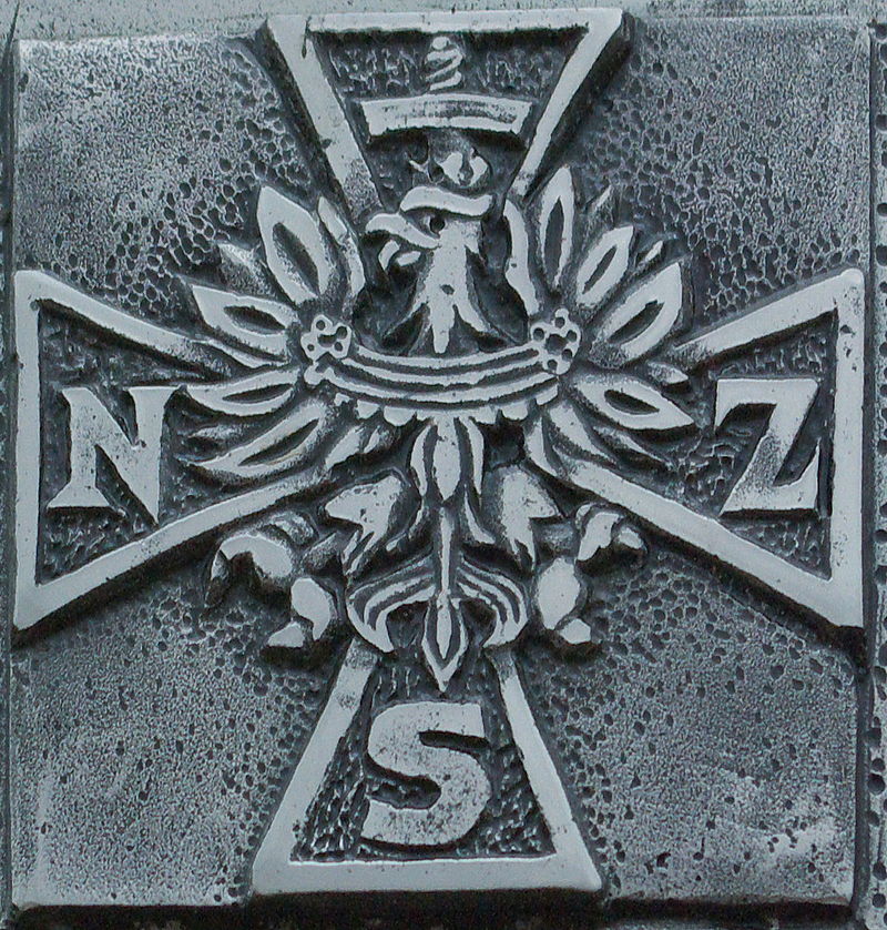 Krzyż NSZ na tablicy pamiątkowej w Sanoku / Źródło: Wikimedia Commons.